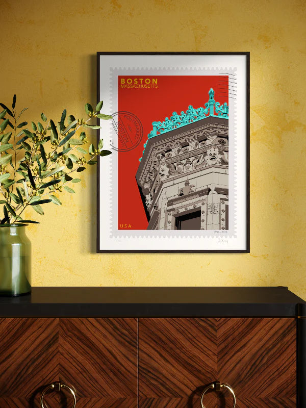 Drawing of the Proctor Building crowned with decorative elements on a red background, featuring the text 'Boston, Massachusetts' and 'USA'. Large postage stamp art, postmarked with D ART Studio stamp. Framed on the wall. Ana Hussey art. 