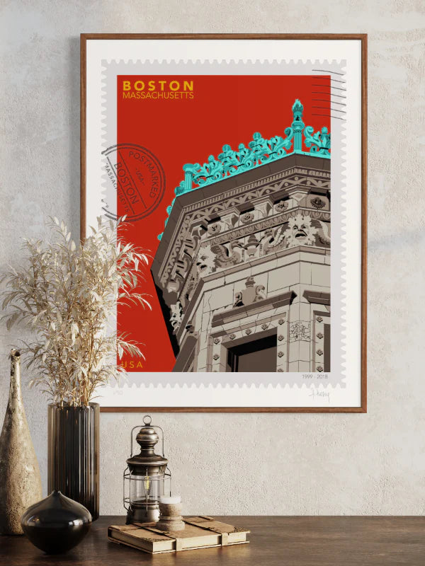 Drawing of the Proctor Building crowned with decorative elements on a red background, featuring the text 'Boston, Massachusetts' and 'USA'. Large postage stamp art, postmarked with D ART Studio stamp. Framed on the wall. Ana Hussey art. 