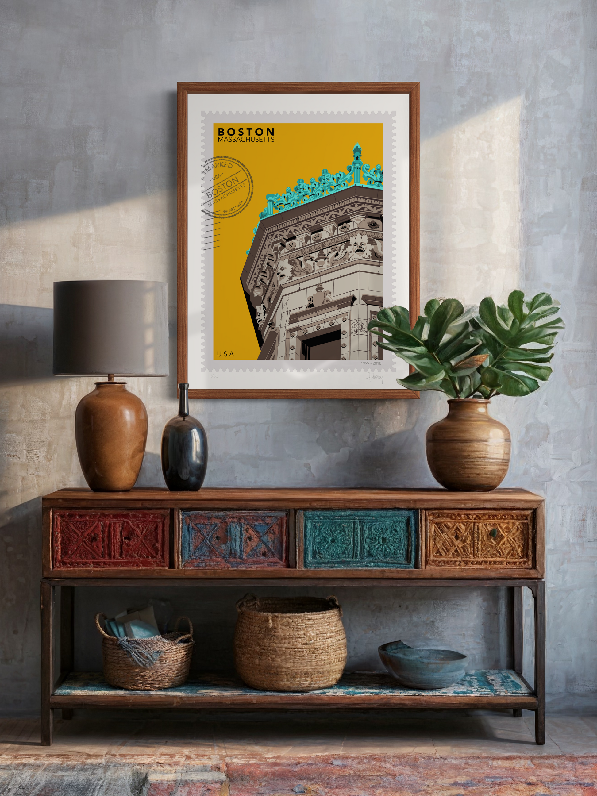 Drawing of the Proctor Building crowned with decorative elements on a yellow background, featuring the text 'Boston, Massachusetts' and 'USA'. Large postage stamp art, postmarked with D ART Studio stamp. Framed on a wall above a wooden console table with decorative items. Ana Hussey art.