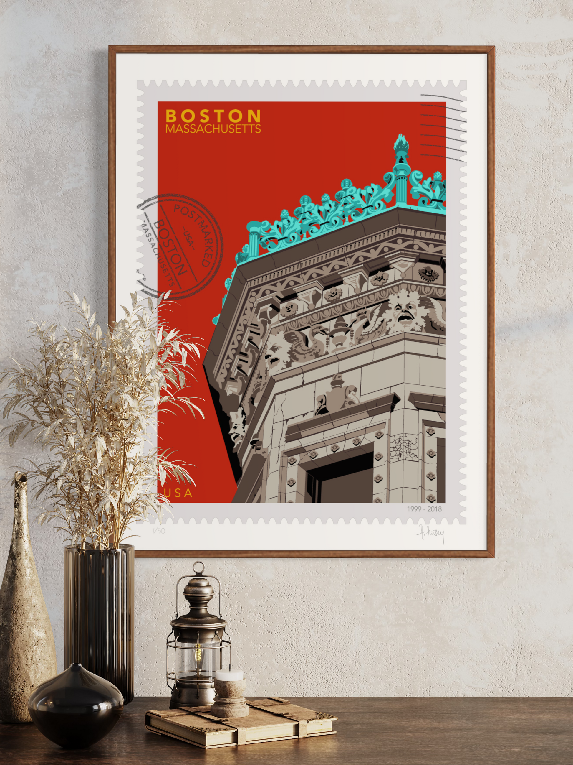 Drawing of the Proctor Building crowned with decorative elements on a red background, featuring the text 'Boston, Massachusetts' and 'USA'. Large postage stamp art, postmarked with D ART Studio stamp. Ana Hussey art. Framed and displayed on a wall with decorative items.