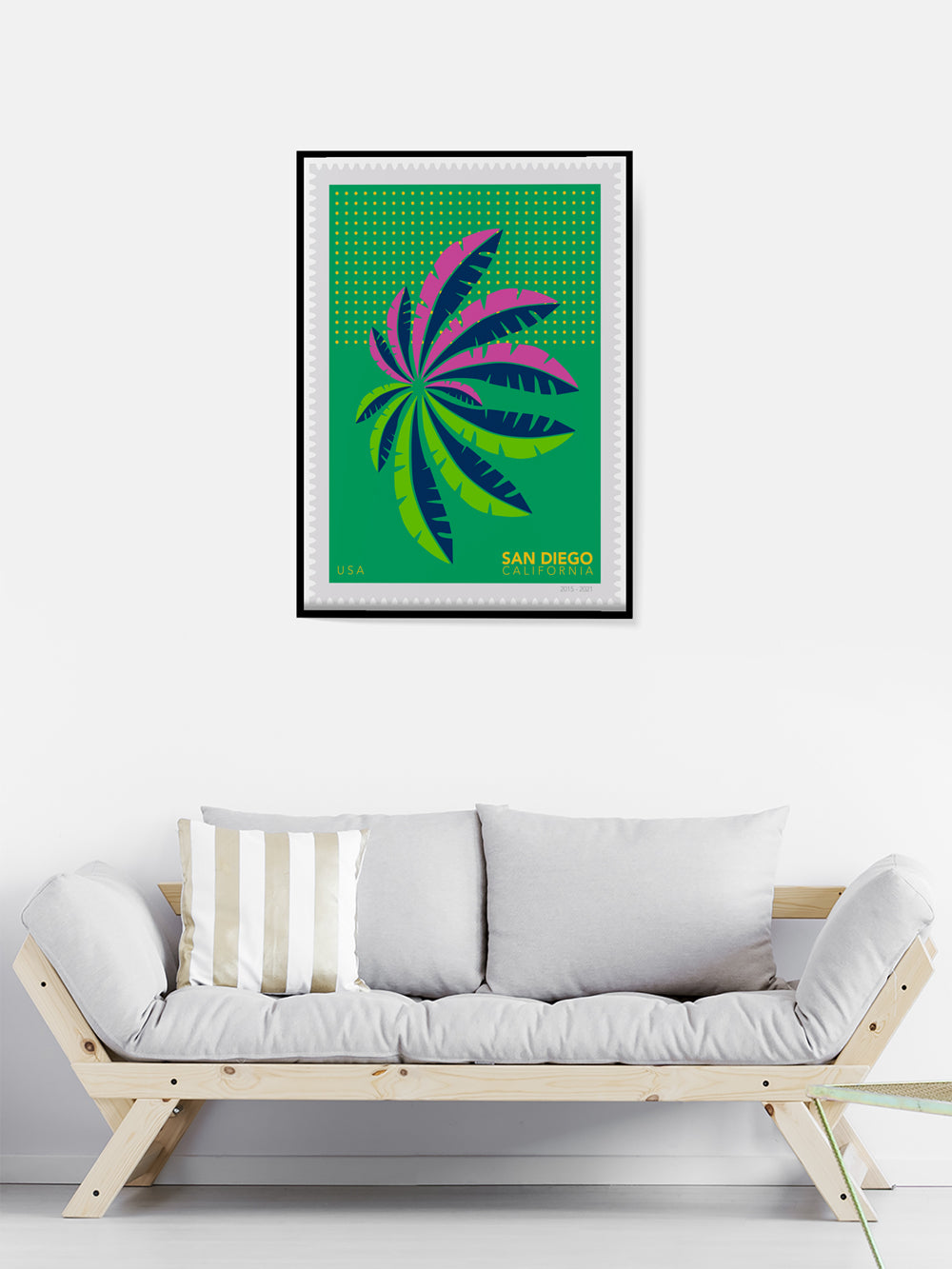 Framed artwork with a colorful design above a wooden sofa in a minimalistic room.