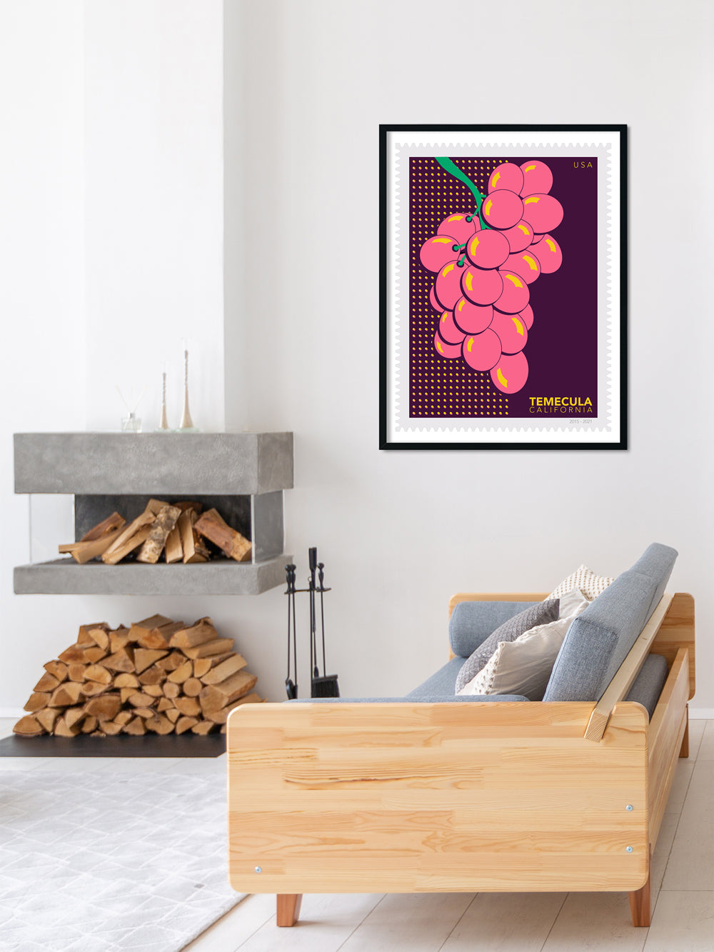 Living room with a wooden sofa, fireplace, and framed artwork of pink grapes.