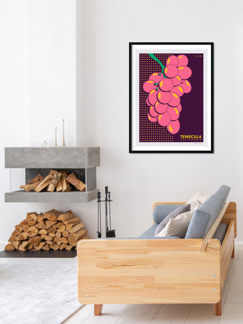 Living room with a wooden sofa, fireplace, and framed artwork of pink grapes.
