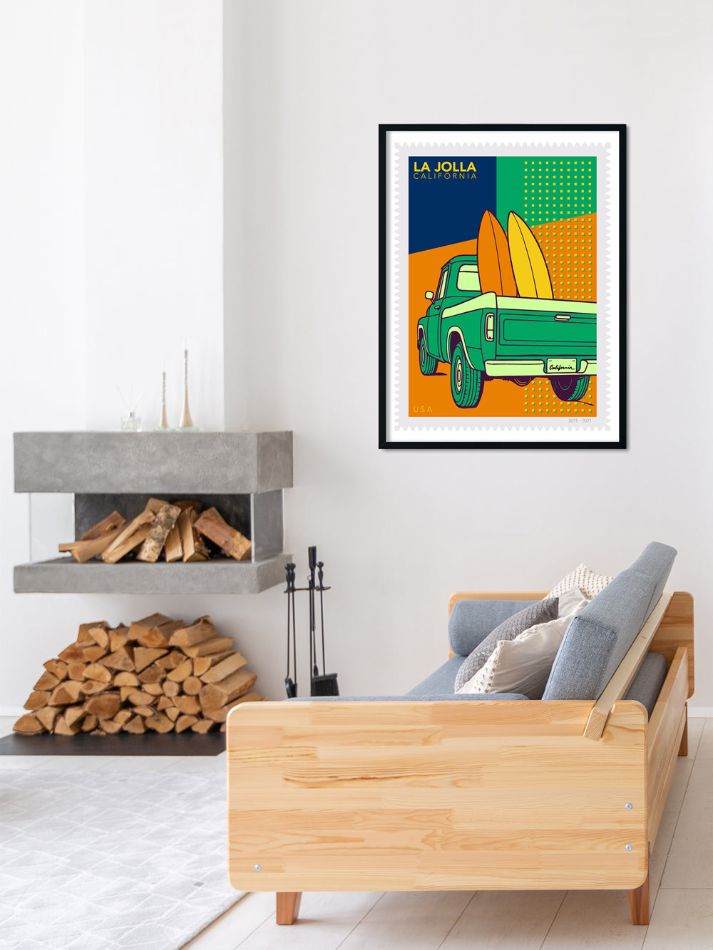 Framed artwork of a truck with surfboards on a wall above a sofa in a living room.