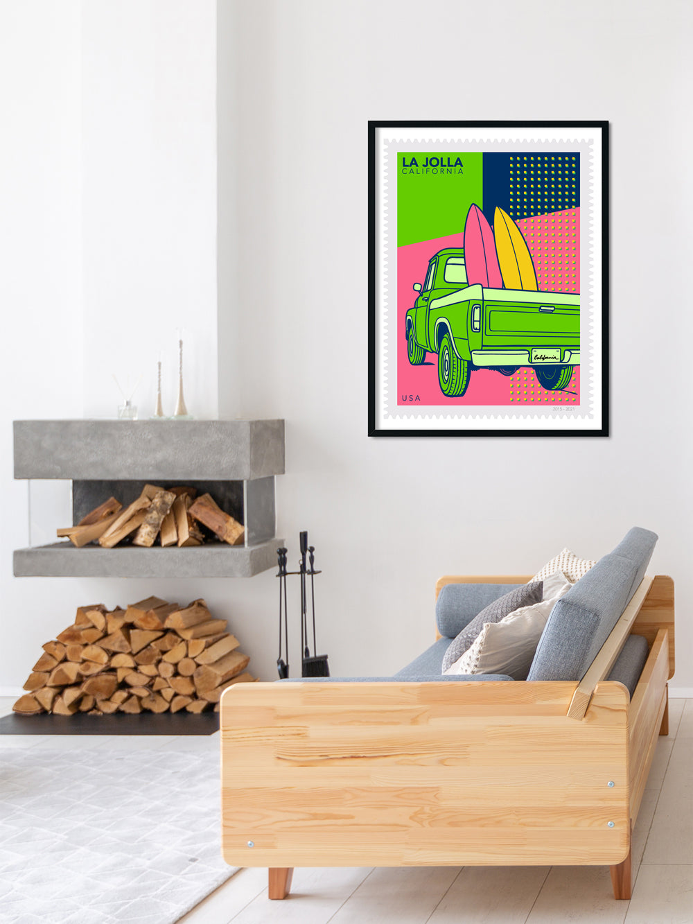 Framed artwork of a green truck with surfboards on a wall above a wooden sofa.