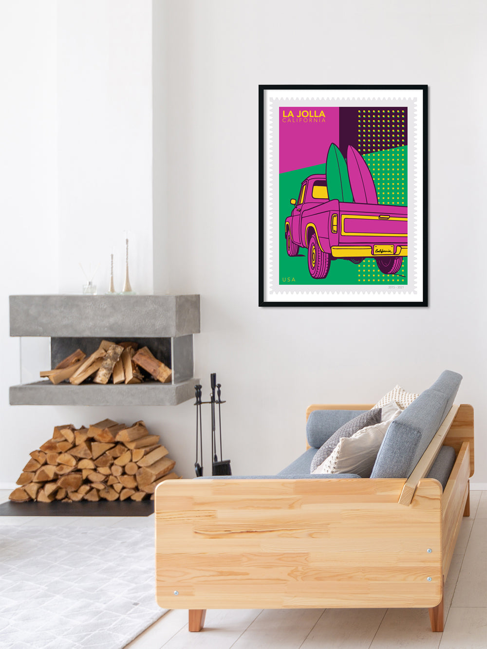 Living room with a wooden sofa, fireplace, and colorful abstract art print of a pink truck.