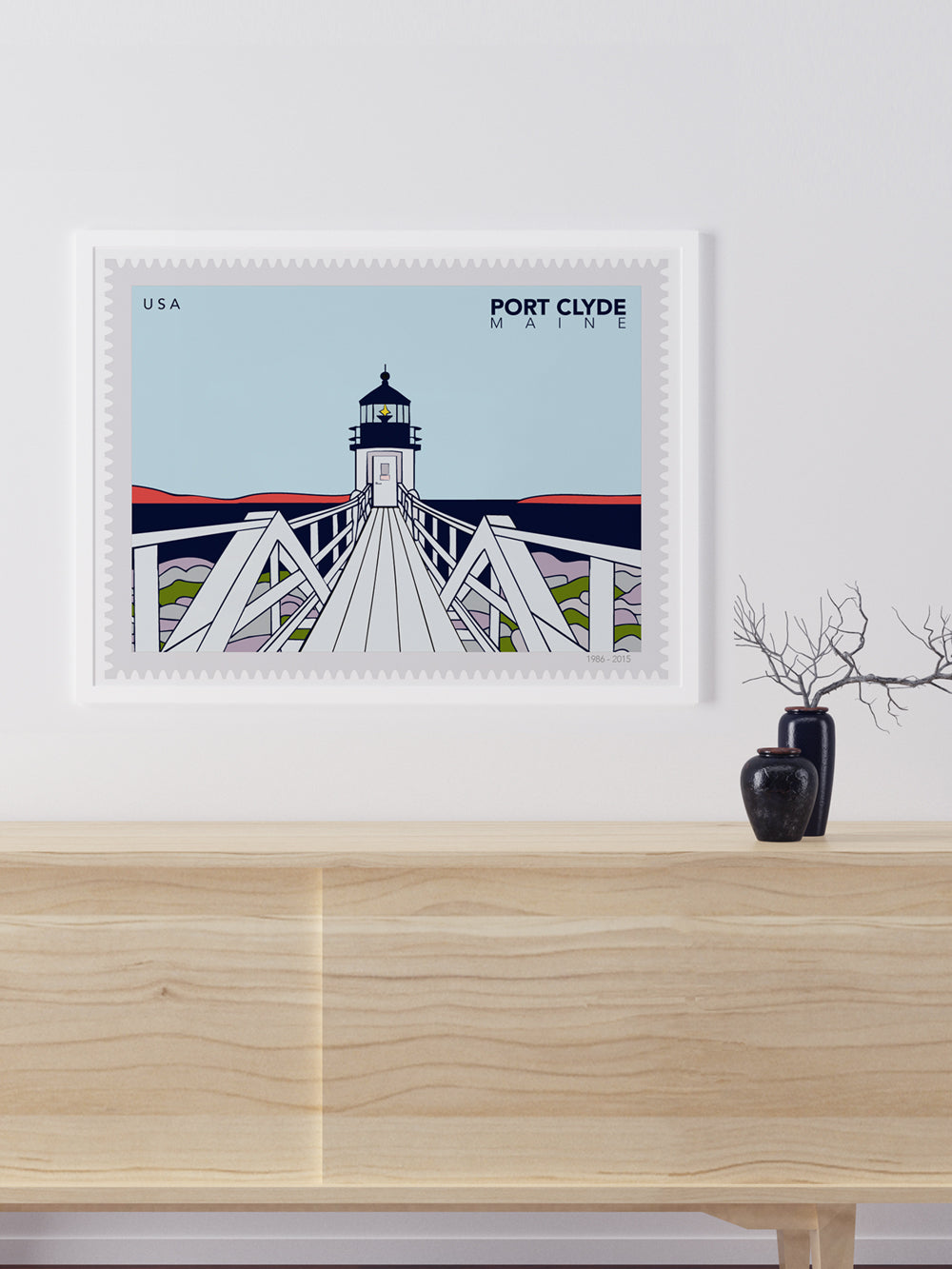 Framed artwork of an Illustration of a lighthouse on a postage stamp with 'Port Clyde, Maine' text.